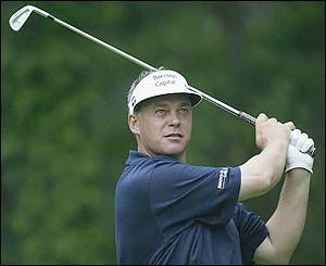 Northern Ireland's Darren Clarke watches after playing an approach shot