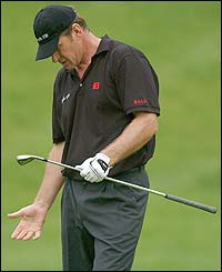 Nick Faldo is frustrated after playing out of the rough