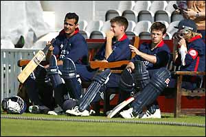 Middlesex batsmen wait at the boundary during their game against Surrey