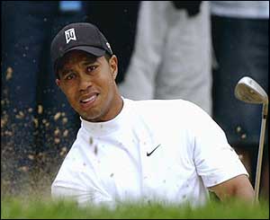 Tiger Woods escapes from a bunker on the eighth hole