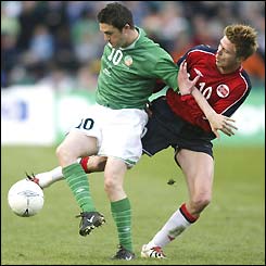 Republic of Ireland's Robbie Keane tussles with Trond Andersen of Norway