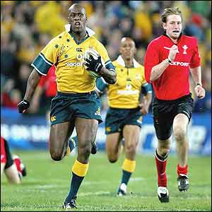 Wendell Sailor sprints clear of the Welsh defence to score the game's opening try