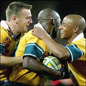 Chris Latham and Australian captain George Gregan congratulate Sailor after he scores the second try