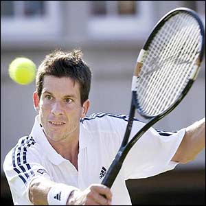 Tim Henman volleys at the net