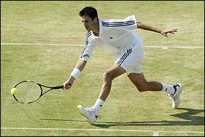 Henman comes into the net to volley