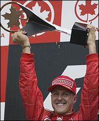 Michael Schumacher holds the trophy aloft after his victory