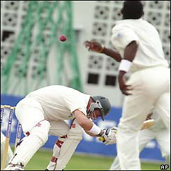 Darren Lehmann ducks from a short ball bowled by Jermaine Lawson 