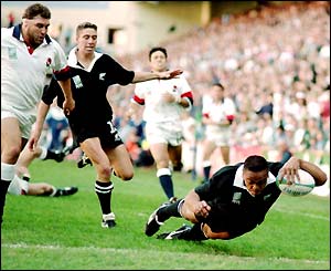 Jonah Lomu dives for one of his four tries in New Zealand's comprehensive win over England