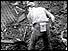 Coal miner digging in rubble 