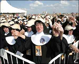 Catholic nuns sing as they wait for the Pope to arrive