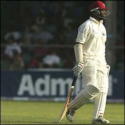 Brian Lara dejectedly walks to the pavillion