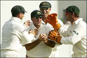 Australian players rush to congratulate their captain on catching Omari Banks