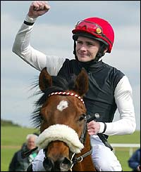 Pat Smullen salutes the crowd after winning the 2,000 Guineas on Refuse To Bend