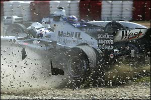 David Coulthard ends up in the gravel after a clash with Trulli