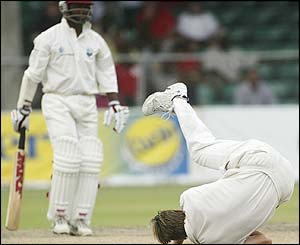 Australia's Andy Bichel takes a tumble