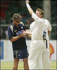 Australia's Brett Lee receives attention for an injury