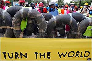 Demonstrators holding sign saying 