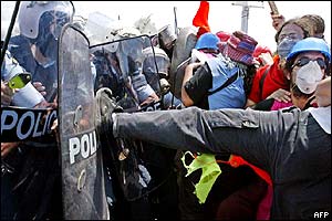 Protester kicks police officers riot shield