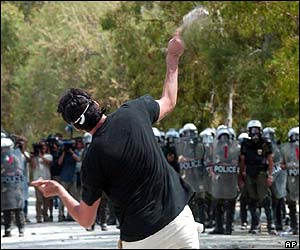 Protester throws bottle at riot police 