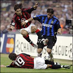 Inter defender Francesco Coco is tackled by AC Milan's Rui Costa and Alessandro Costacurta