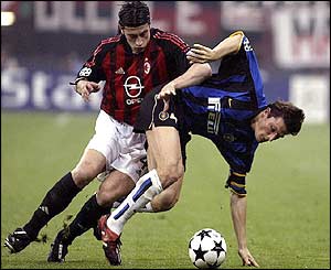 Inter Milan's Javier Zanetti shields the ball from AC Milan's Kakha Kaladze