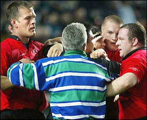 Referee Alan Lewis steps in to break up a row