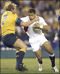 England wing Jason Robinson runs through a tackle