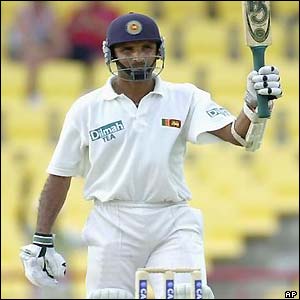 Atapattu raises his bat to the crowd to celebrate his ton