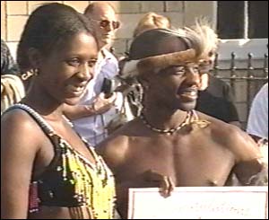 Members of attending crowds outside castle gates