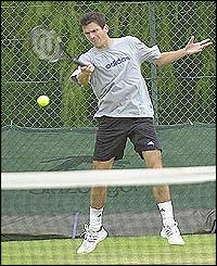 Tim Henman plays a forehand during practice