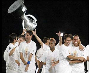 Real Madrid players hold a replica trophy aloft