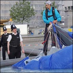 Mr Connery is spoken to by officers as he gathers up his parachute