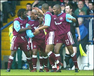 Trevor Sinclair is mobbed by his team-mates after another crucial goal