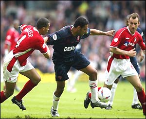 Carl Asaba fends off Des Walker 