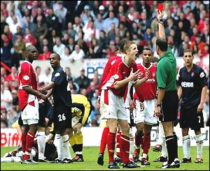 The referee shows Nottingham Forest defender Michael Dawson the red card