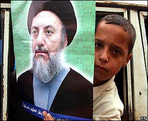 A boy holds a picture of the Ayatollah 
