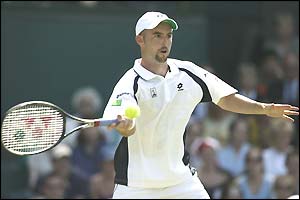Jamie Delgado plays a forehand on the way to winning the third set against Andre Agassi