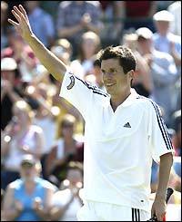 Henman waves to the crowd after wrapping up a four-set victory