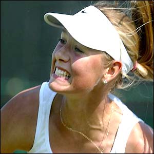 Maria Sharapova grits her teeth as she serves to Ashley Harkleroad