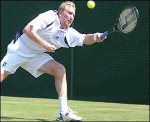 Martin Lee stretches to reach a forehand