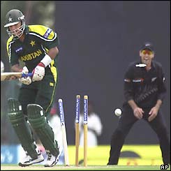 Faisal Iqbal's stumps are hit by Shane Bond