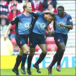 Dennis Bergkamp congratulates Thierry Henry on scoring the first goal for Arsenal
