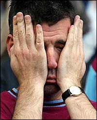 The pressure shows on a West Ham fan at St Andrews