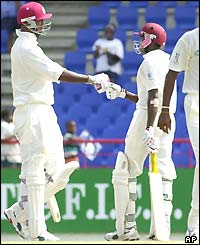 Jerome Taylor shakes hands with West Indian team-mate Omari Banks after Banks reaches his fifty