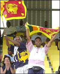 Sri Lankan fans wave their national flag to support their team
