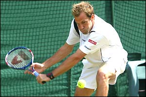 Greg Rusedski returns during his match with Andy Roddick