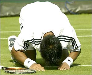 Paradorn Srichaphan bows down on the court after beating Olivier Mutis in five sets