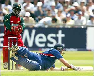 Anthony McGrath dives for his crease and survives a run-out attempt