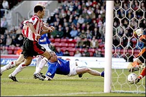 Millwall's Steve Claridge pokes the ball into the Southampton net
