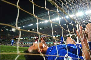 John Terry lies in the back of the net after scoring an own goal